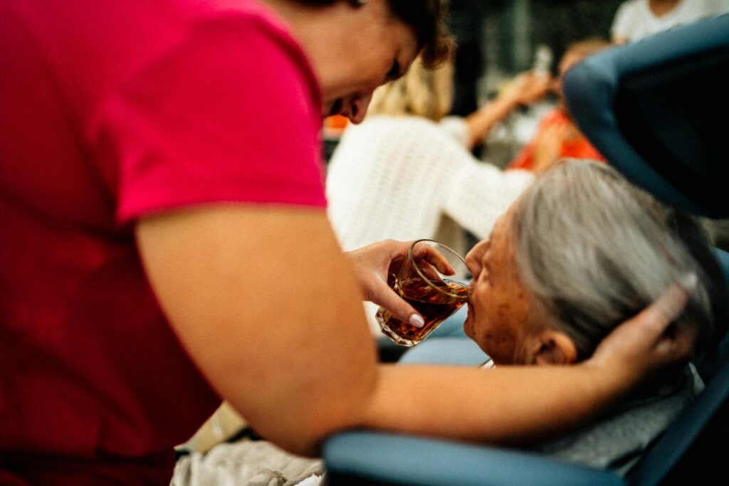 pexels photo 16364307 16364307 A caregiver helps an elderly woman drink tea, showcasing empathy and support.